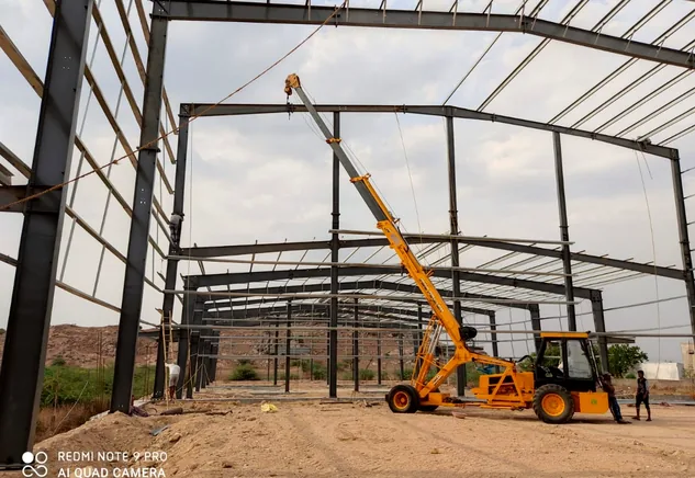 Portal frame erection in progress with mobile crane